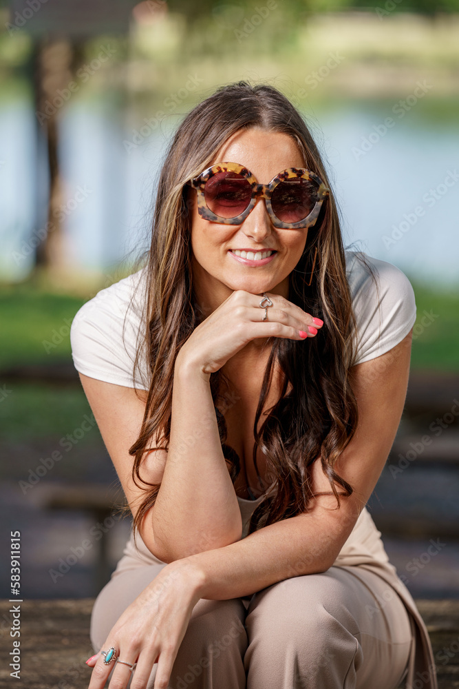 Fashionable young woman posing with oversized sunglasses