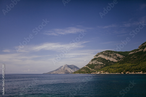 Landscape of the Adriatic Sea, mountains with clouds, sky, rocks on a sunny day. Dalmatia, Croatia. © Grzegorz