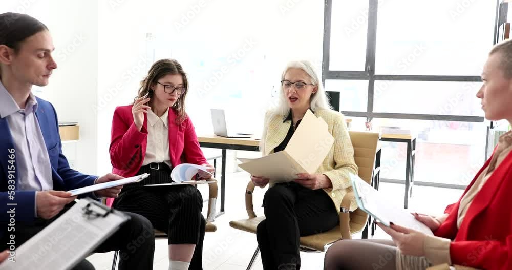 Business coach with documents in hands training interns in audience 4k movie slow motion Business coach with documents in hands training interns in audience 4k movie slow motion