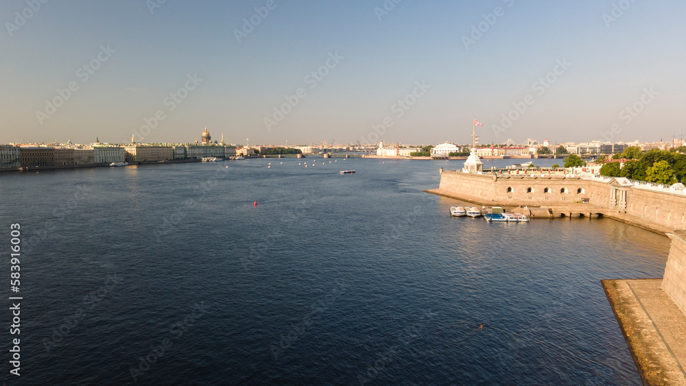 Aerial  above view of the Peter-Pavel's Fortress next to bridges and Sailing ship on the river and water channel in the historical centre of city of St. Petersburg at clear summer morning
