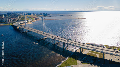Aerial view of the center of the Cable-stayed Bridge and the Highway next to the buildings on the banks of the Neva at summer day