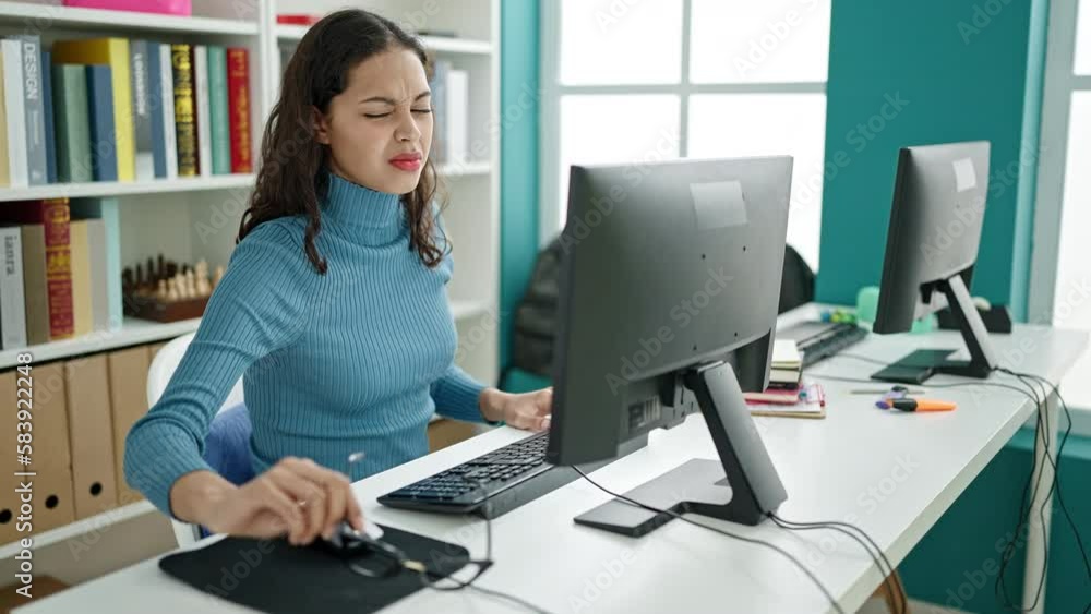 Young beautiful hispanic woman student with problem to see screen at university classroom Young beautiful hispanic woman student with problem to see screen at university classroom
