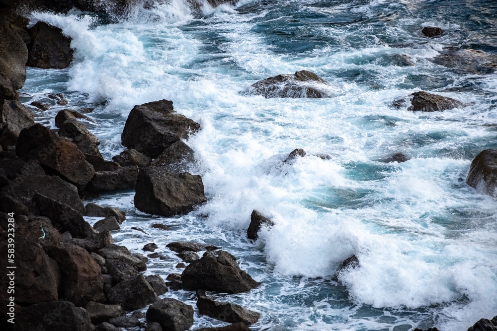 The sea sparkled like a sapphire against the rugged backdrop of weathered stones. The sea sparkled like a sapphire against the rugged backdrop of weathered stones.