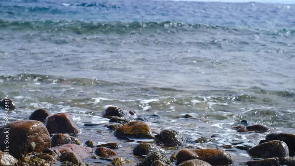 Powerful sea waves break on the coast of the Red Sea. Waves crash on a pebble beach during a storm. Storm in the sea. Panoramic view of the red sea Powerful sea waves break on the coast of the Red Sea. Waves crash on a pebble beach during a storm. Storm in the sea. Panoramic view of the red sea