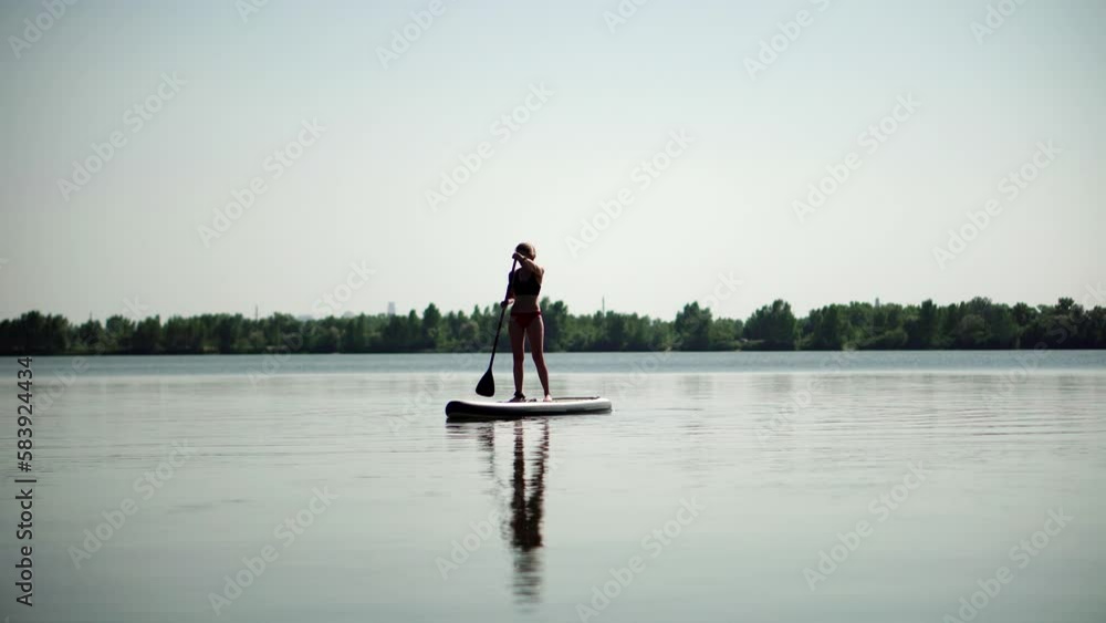 woman engaging in water tourism using raft, SUP board, and surfboard woman engaging in water tourism using raft, SUP board, and surfboard