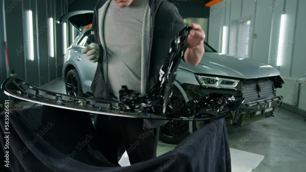 Gluing the film on the spoiler to protect the paint which protects the