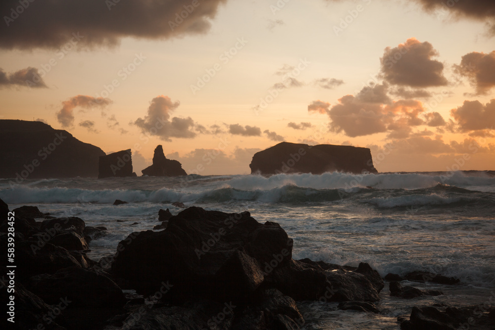 Stony beach with cloudy sky during sunset Stony beach with cloudy sky during sunset