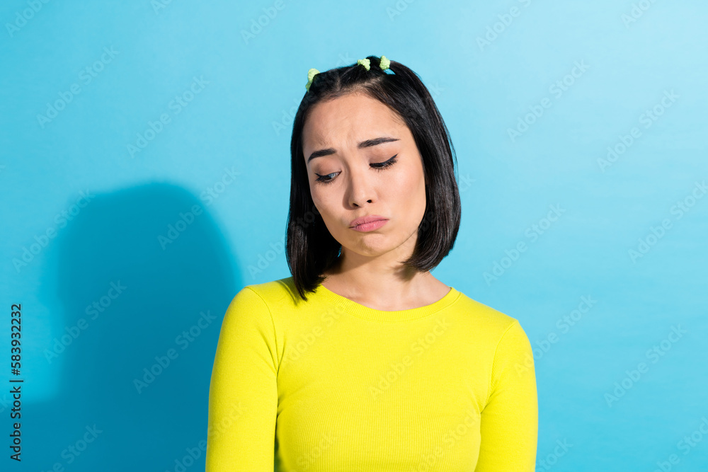 Creative photo portrait of youngster korean girl with ponytails hair pouted lips look down feel offended displeased isolated on blue color background - obrazy, fototapety, plakaty 