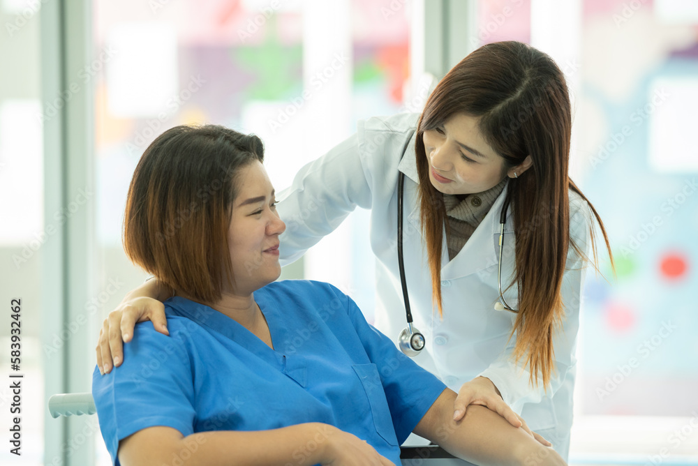 woman obstetrician doctor look holding hand to consoling encourage woman pregnant patient on wheelchair in hospital. woman doctor talk diagnosis treatment for mother pregnancy woman obstetrician doctor look holding hand to consoling encourage woman pregnant patient on wheelchair in hospital. woman doctor talk diagnosis treatment for mother pregnancy
