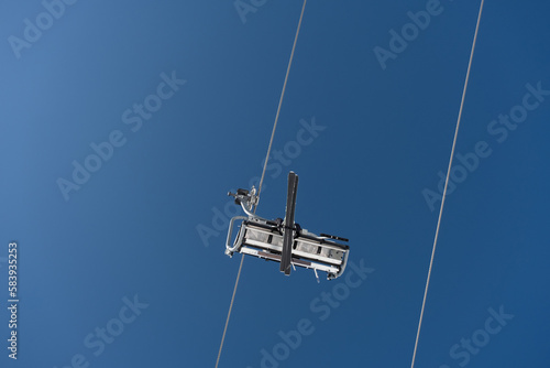 Vertical shot of cableway cabin with a skier