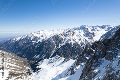 Aerial shot of a grand snow covered mountain range