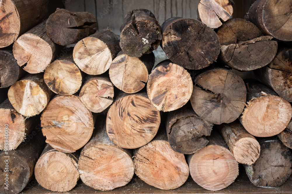 A pile of rustic firewood in a warehouse waiting to be used to make fire A pile of rustic firewood in a warehouse waiting to be used to make fire