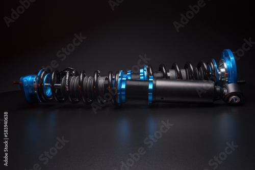 auto suspension tuning coilovers shock absorbers and springs blue for a sports drift car on a dark background