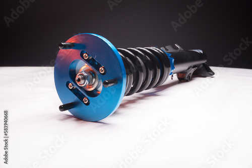 auto suspension tuning coilovers shock absorbers and springs blue for a sports drift car on a dark background