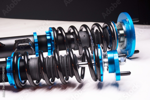 auto suspension tuning coilovers shock absorbers and springs blue for a sports drift car on a dark background