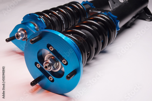 auto suspension tuning coilovers shock absorbers and springs blue for a sports drift car on a dark background