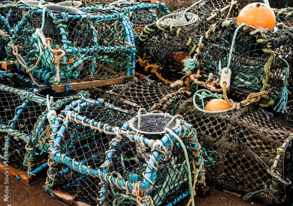 Selective focus shot of fishermen's lobster pots on a pile drying on a harbor