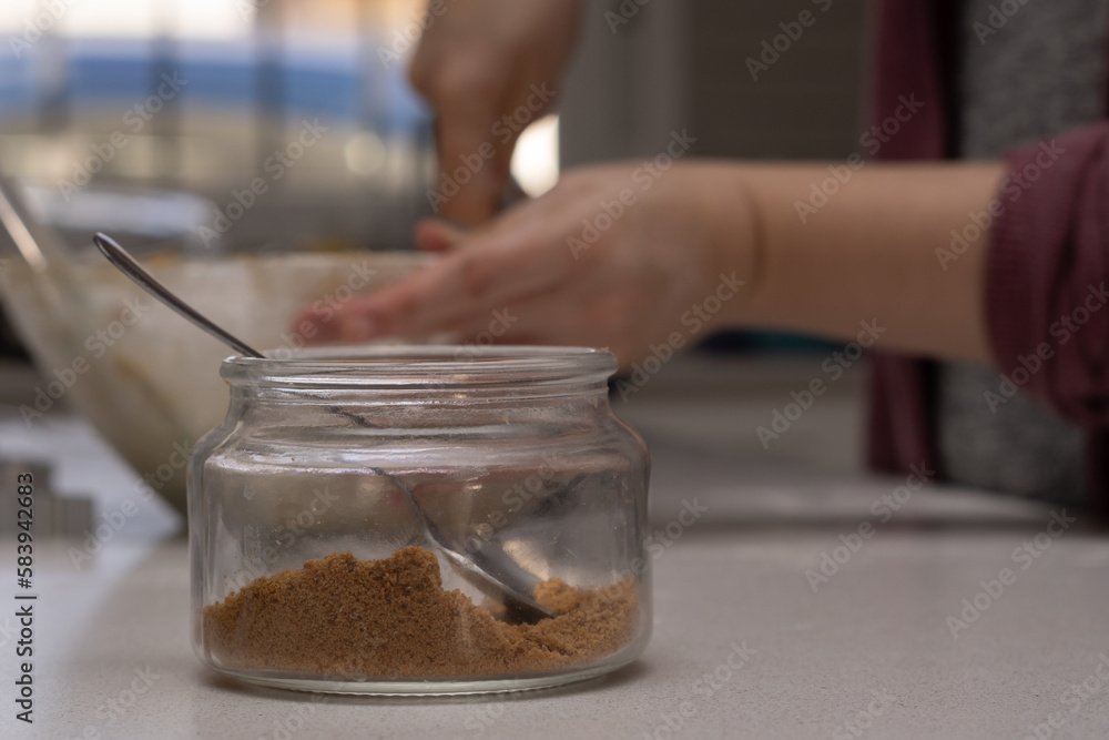 glass jar with brown sugar and a spoon glass jar with brown sugar and a spoon