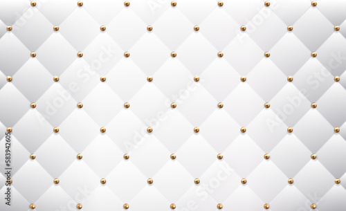 The texture of quilted leather with gold buttons