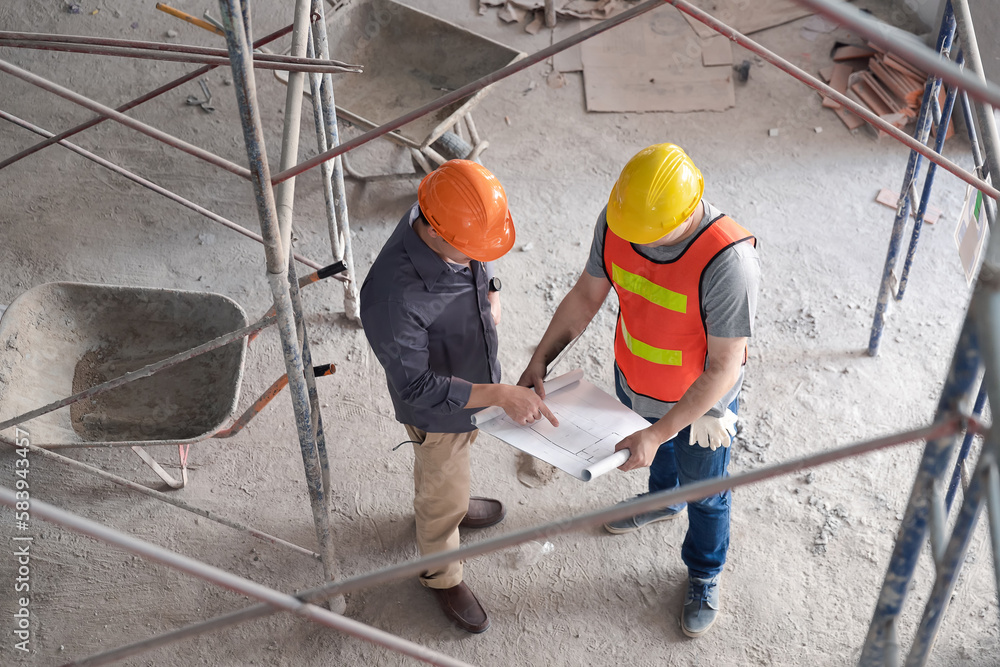 Top view of Confident team of architect working together in building construction site. They discussing about new startup project. Architect discuss with engineer about project.