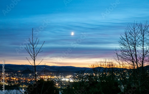 view over Inverness city from above the Kessock Bridge on a moonlit winter's night in Scotland photo