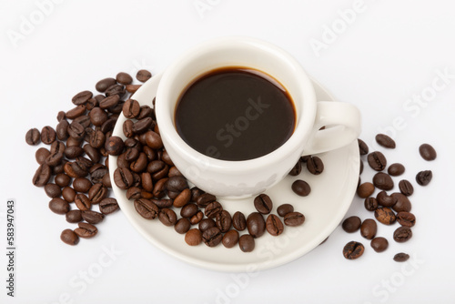 A cup of aromatic espresso coffee isolated on a white background. Coffee beans in a cup. Energy drink. A refreshing aromatic morning drink.