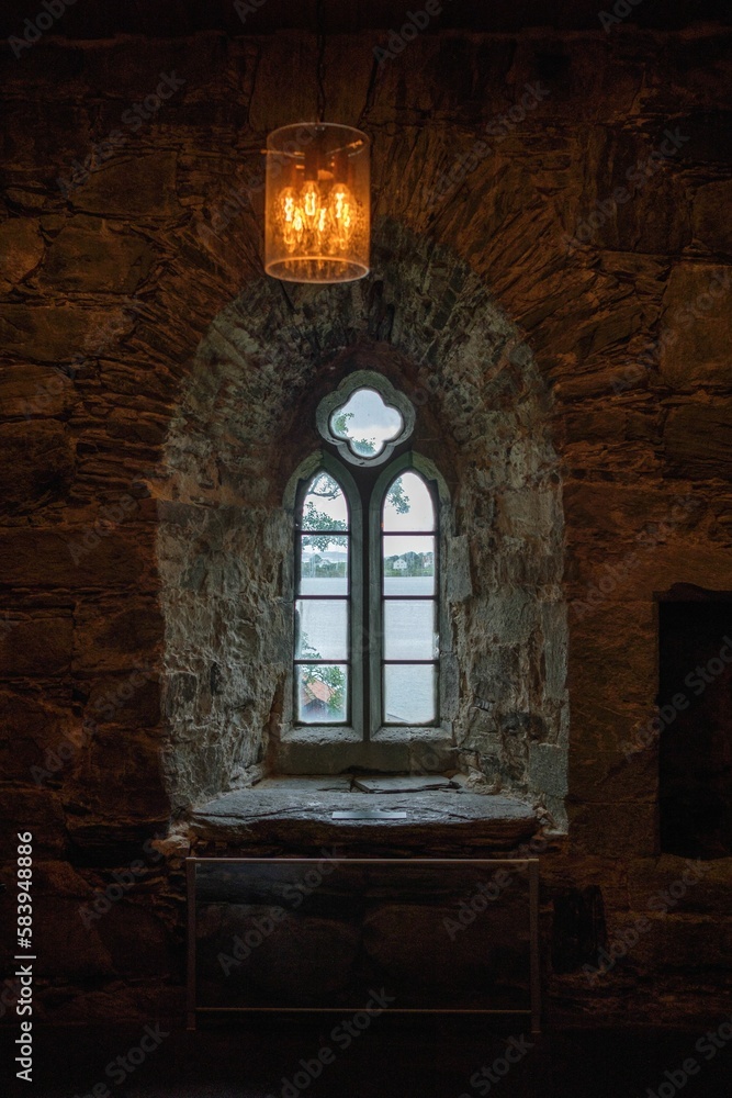 Vertical shot of the beautiful windows in the historic Utstein monastery in Norway