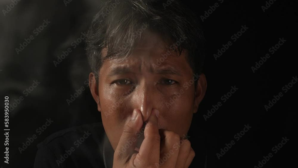 Smoke cigarette air pollution with health and environmental impacts concept. Asian man be scared smog pollution. Smoke cigarette air pollution with health and environmental impacts concept. Asian man be scared smog pollution.
