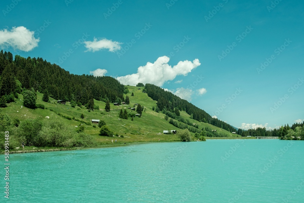 Beautiful view of the Lag da Beil lake under a blue sky in the Swiss mountains in the Surselva area