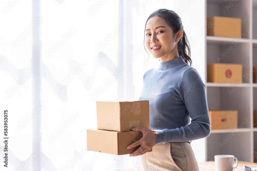 Portrait of Starting Asian female small businesses owners SME entrepreneur working at Laptop in home Warehouse, online marketing, packing boxes, SME sellers, concept, e-commerce team, online sales.
Portrait of Starting Asian female small businesses owners SME entrepreneur working at Laptop in home Warehouse, online marketing, packing boxes, SME sellers, concept, e-commerce team, online sales.