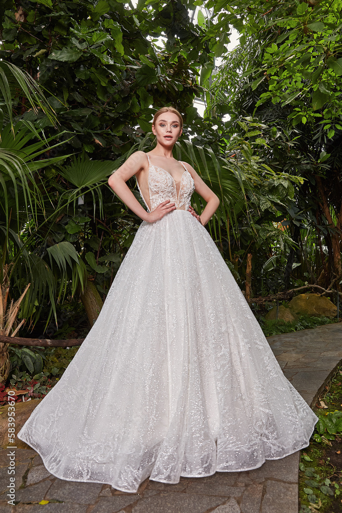 Fototapeta premium Sexy beautiful woman pretty bride wedding big day marriage ceremony in summer garden wearing long silk and lace white dress bright makeup hairstyle pure love.