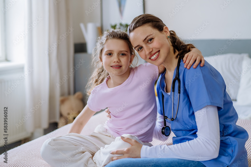 Young doctor taking care of little girl in hospital room. Young doctor taking care of little girl in hospital room.