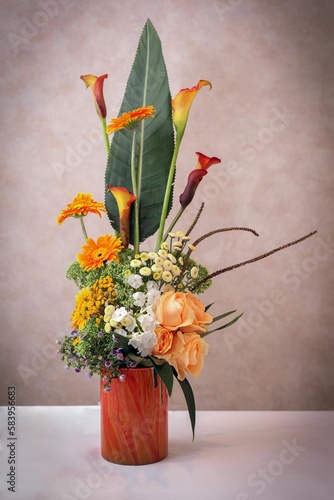 Vertical shot of a beautiful bouquet of flowers on the grey background