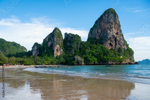 Railay beach with large cliffs and greenery