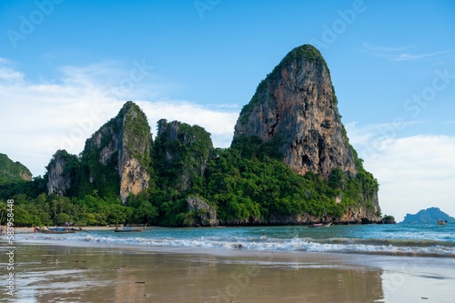 Railay beach with large cliffs and greenery
