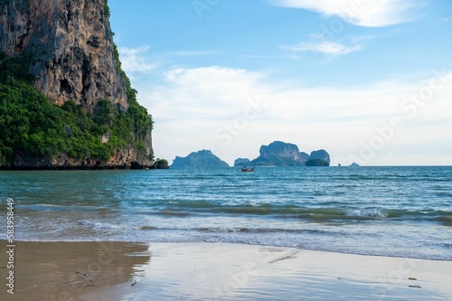 Railay beach with large cliffs and greenery