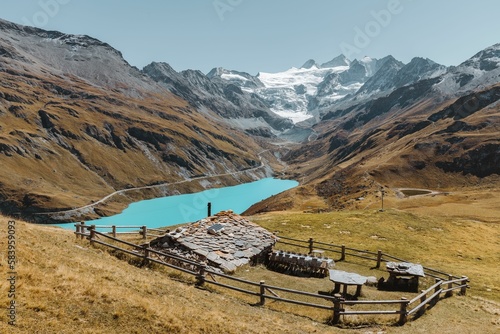 Swiss chalet in a meadow overlooking the Lake and Glacier of Moiry photo