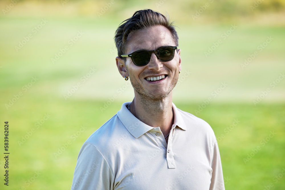 Portrait of smiling Caucasian man wearing sunglasses in Summer in green field Portrait of smiling Caucasian man wearing sunglasses in Summer in green field