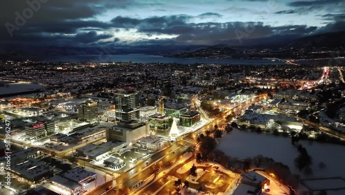 Aerial view of the mesmerizing Kelowna city with buildings and streets lit at night photo