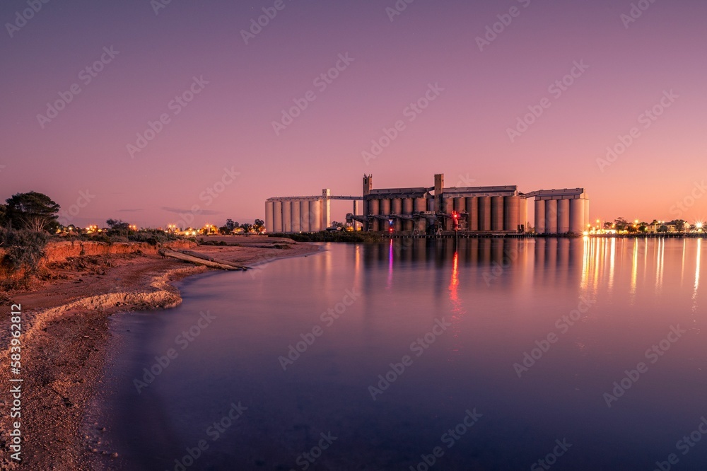 Fototapeta premium Aerial view of Port Pirie on river during sunset