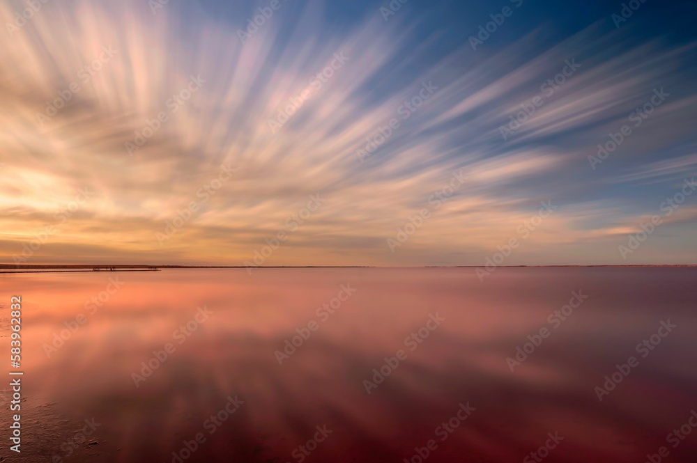 Aerial view of lake under colorful sky during sunset