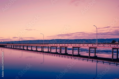 Aerial view of bridge over lake during sunset