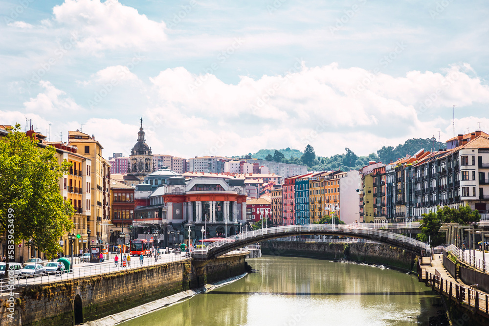 Bilbao city with the Ribera Market, the colorful architecture and the Nervion river on a sunny day. Enjoying a nice vacation in the Basque Country, Spain