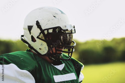 Football player wearing a helmet and visor outdoors photo