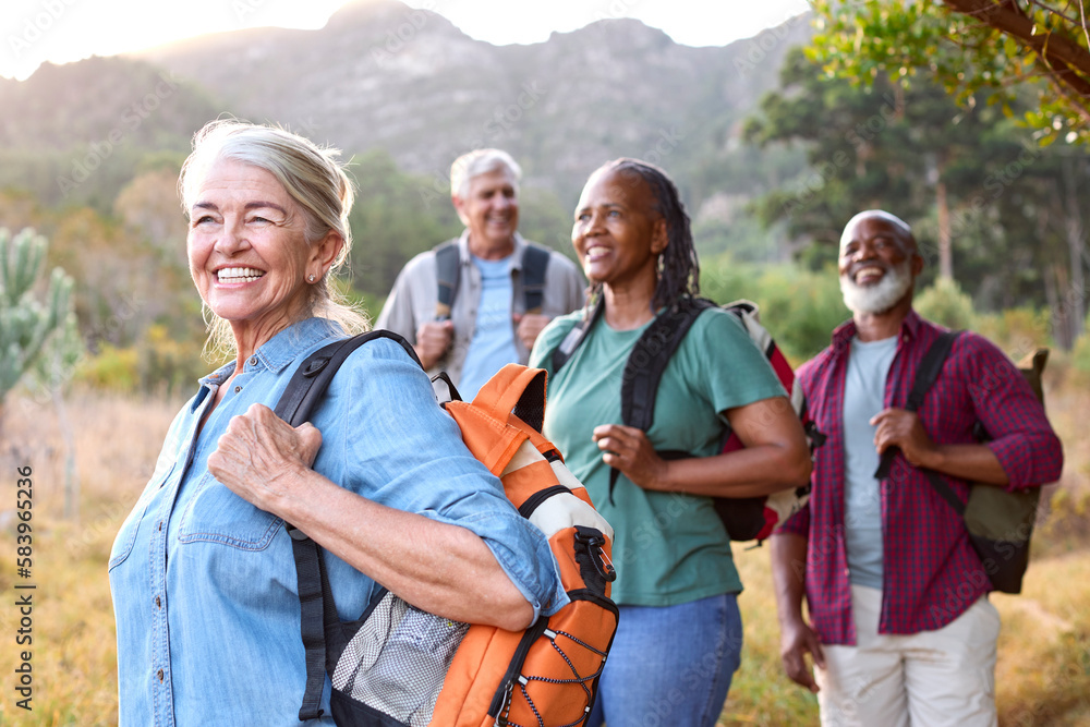 Group Of Senior Friends Enjoying Hiking Through Countryside Together Group Of Senior Friends Enjoying Hiking Through Countryside Together