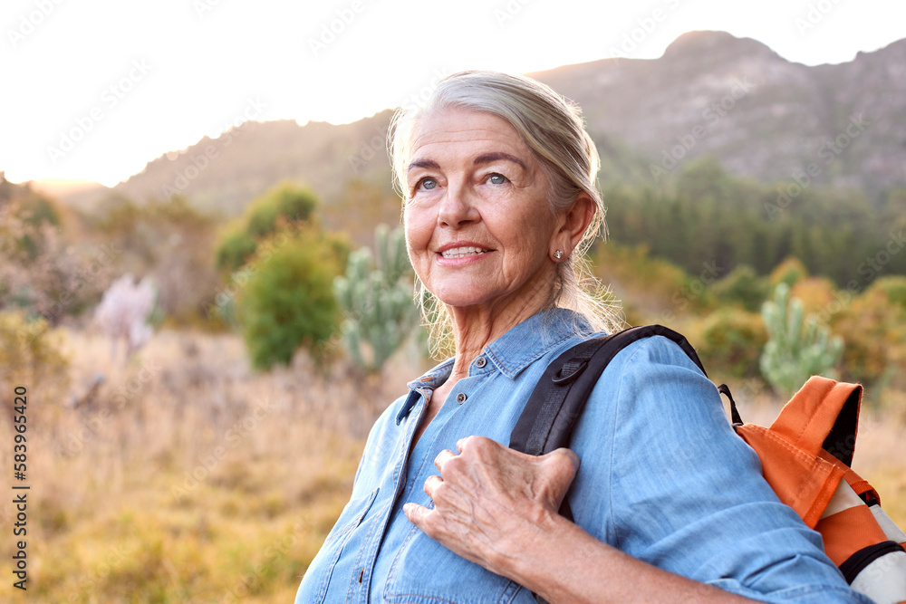 Portrait Of Active Senior Woman With Backpack Going For Hike In Countryside Portrait Of Active Senior Woman With Backpack Going For Hike In Countryside