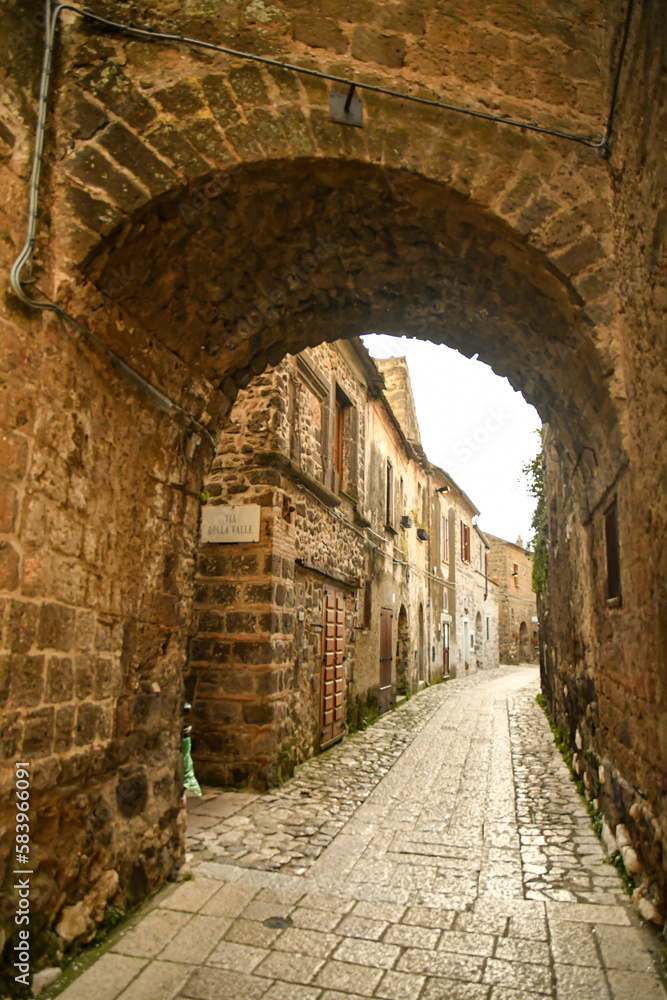 Narrow street among the old stone houses of the oldest district of the city of Caserta