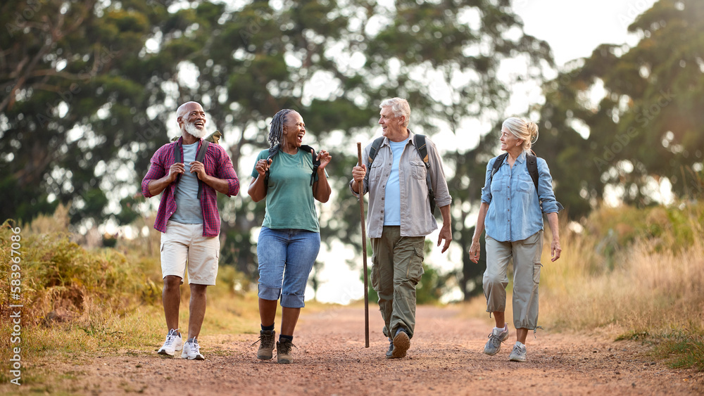 Group Of Active Senior Friends Enjoying Hiking Through Countryside Walking Along Track Together Group Of Active Senior Friends Enjoying Hiking Through Countryside Walking Along Track Together