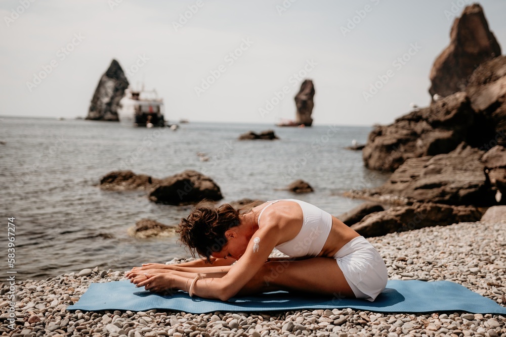 Woman sea yoga. Two Happy women meditating in yoga pose on the beach, ocean and rock mountains. Motivation and inspirational fit and exercising. Healthy lifestyle outdoors in nature, fitness concept. Woman sea yoga. Two Happy women meditating in yoga pose on the beach, ocean and rock mountains. Motivation and inspirational fit and exercising. Healthy lifestyle outdoors in nature, fitness concept.