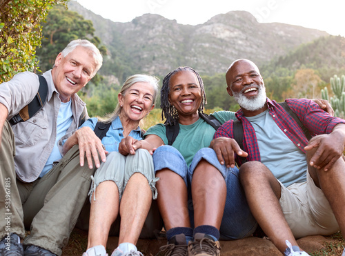 Portrait Of Active Senior Friends Sitting Taking A Break Hiking Through Countryside Together © Monkey Business